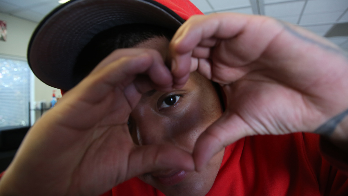 BNC team member making the heart sign with their hands